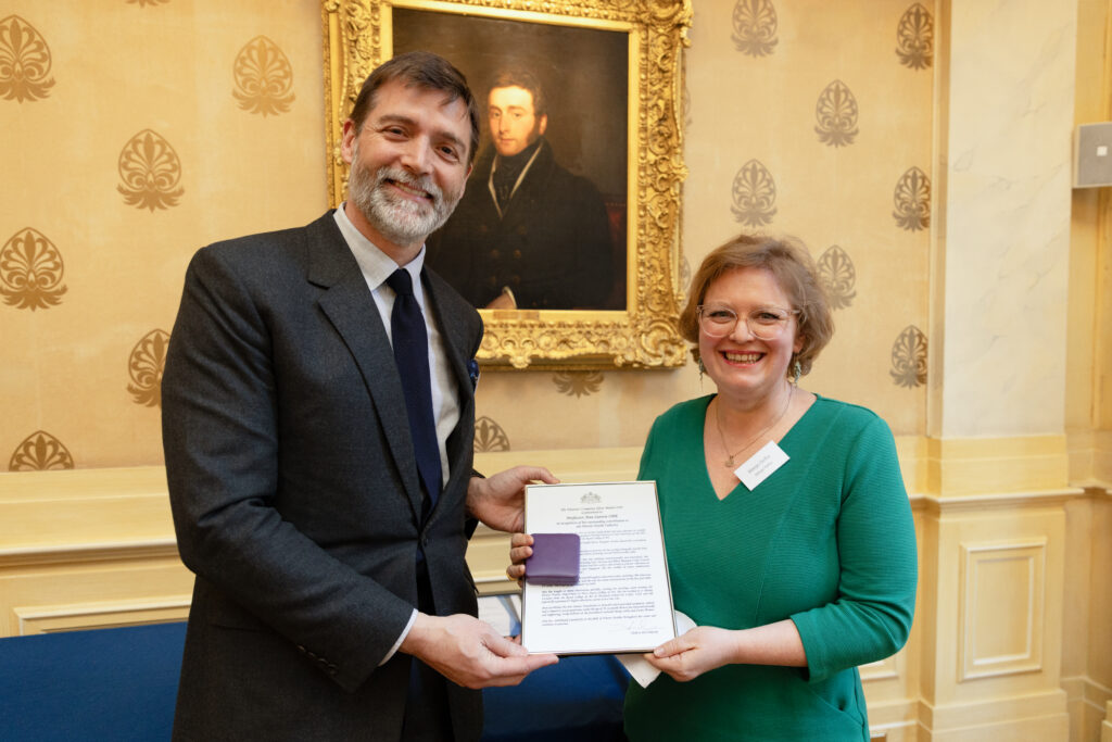 Margo Selby receiving the Silver Medal on behalf of Ann Sutton